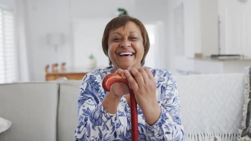 Cheerful Senior Woman Smiling with a Walking Stick