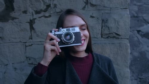 Smiling Woman Poses with Vintage Camera