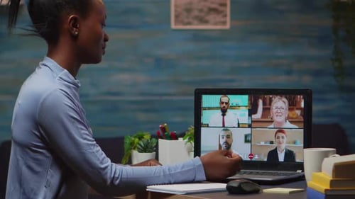 Woman Attends Virtual Meeting on Laptop