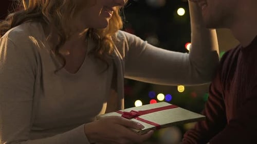 Loving Couple Exchange Gifts at Christmas time