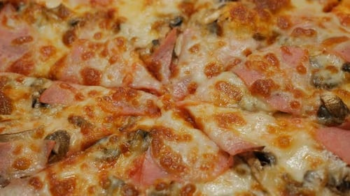 Tasty pizza baked with bacon and vegetables close-up surface 4K 2160p 30fps UltraHD video - Pizza