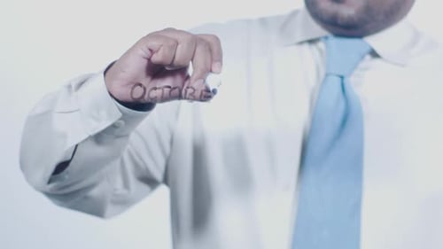 Close Up of Man Writing October