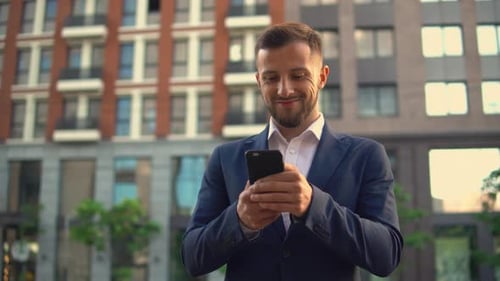 Man in Suit Using Cell Phone Outdoors