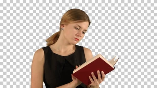 Young beautiful girl reading a book on laptop, Alpha Channel