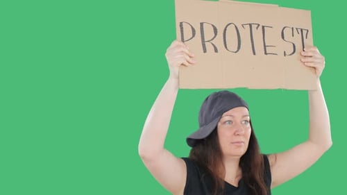 Woman Holding Protest Sign on Green Background