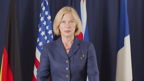 Woman Standing in Front of International Flags