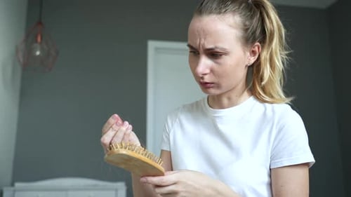 Drop-down Hair in Female Hands with Comb