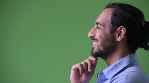 Profile View of Young Happy Bearded Indian Businessman Thinking