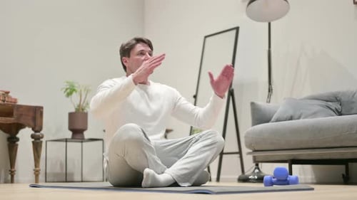 Man Meditating on Yoga Mat Indoors