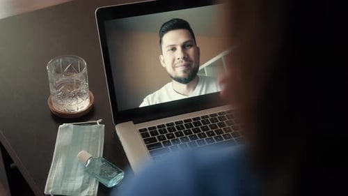 Young Woman Smiling While Videoconferencing at Home During Coronavirus Self Quarantine
