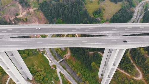 Aerial View of the Highway Viaduct on Concrete Pillars with Traffic in Mountains
