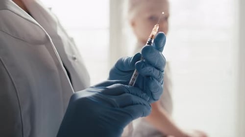 Healthcare Provider Giving Injection to Child