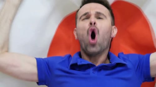 Man Shouting While Holding a Flag