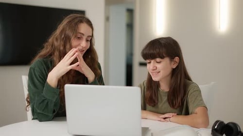Young Adult and Child Using Laptop Indoors