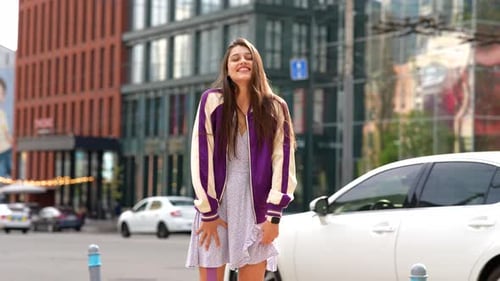 Playful Portrait of Pretty Young Woman Having Fun at the Street