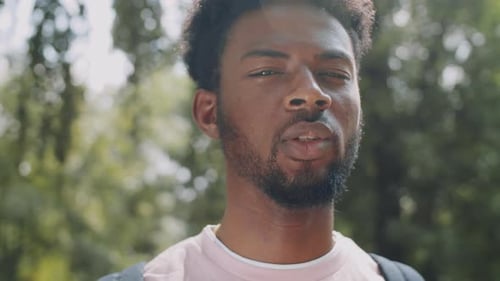 Young Adult Smiles Outdoors in City Park