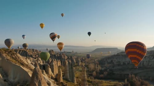 Majestic Balloons Floating Over Unique Valley Landscape