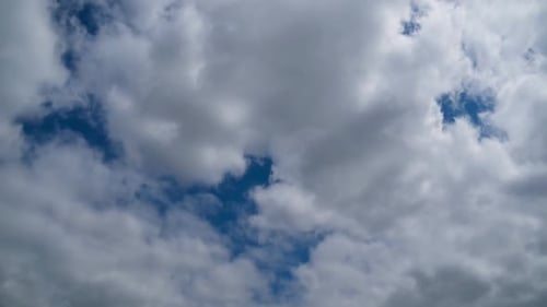 Billowing Clouds Drifting Across a Blue Sky