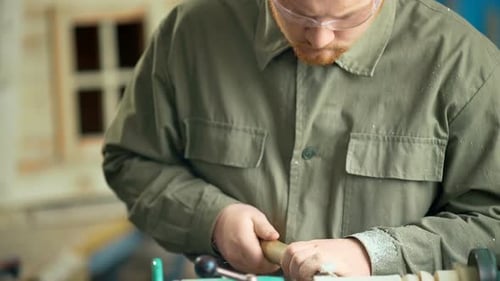 Carpenter Working with Machine in Workshop