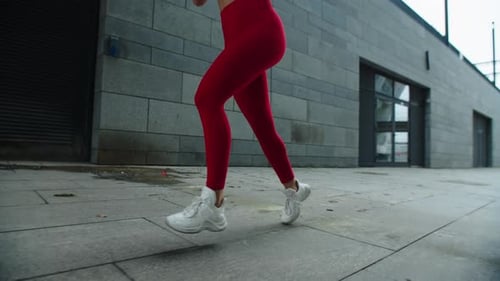 Girl Legs Running Outdoor in Slow Motion. Close Up Female Legs Running on Street
