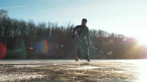 Hockey Player on Frozen Lake Make Ice Sparkles on High Speed Braking.hockey Stick in Hands, Canadian