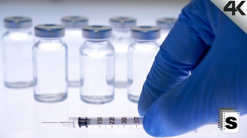 Vials and Syringe in Medical Setting