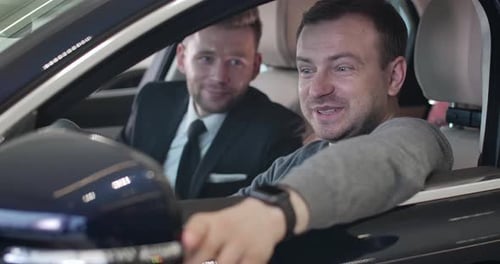 Man Discusses Car Details with Salesman