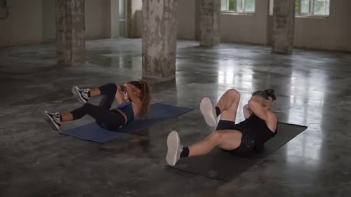 Woman and Man Doing Abs Workout in Studio