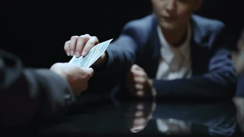 Business Deal Involving Cash Exchange in Dark Room