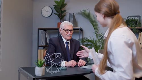 Senior Businessman Company Entrepreneur Ceo Examining Financial Data with Young Woman Colleague