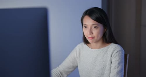 Woman work on computer at night