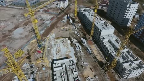 Aerial footage of construction site with building cranes