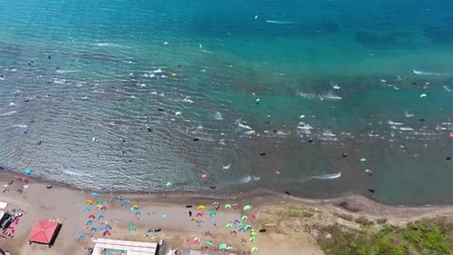 Kiteboarding, Kitesurfing Kiters and Kiteboarders are Pulled Across Sea Water by a Wind Power Kite