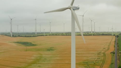AERIAL: Wind Mill Rotating By the Force of the Wind and Generating Renewable Energy in a Green