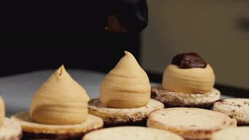 Hands Adding Caramel to Cakes in Creamy Close Up