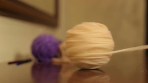 Peach Yarn Ball on Shiny Brown Surface