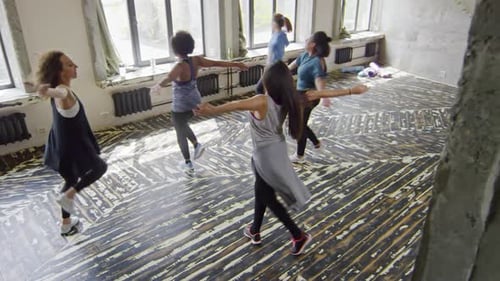 Women Dancing Energetically in Urban Studio