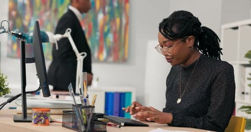 Beautiful Woman with Glasses Darkskinned Company Secretary Sits in Office in Front of Computer