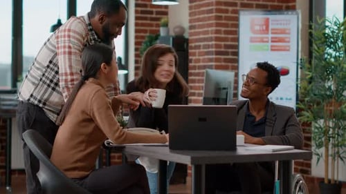 Diverse Team Discussing Project in Modern Office