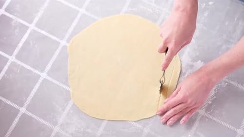 Apple Pie Cake Preparation Series Frau schneidet gerollten Teig mit Rollmesser