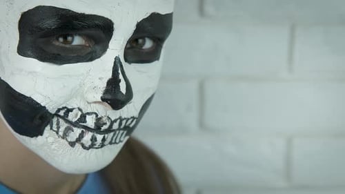 Child with face of Halloween.