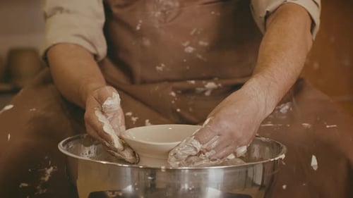 Potter Forming Clay Bowl on Pottery Wheel