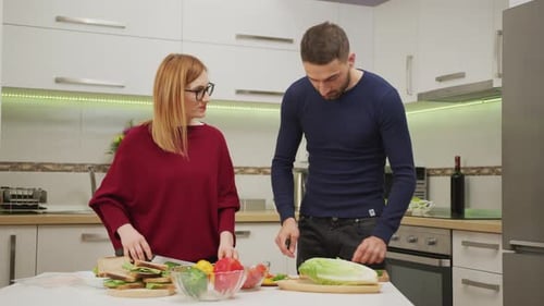 Young Couple Cooking in Bright Kitchen Together