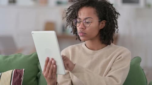 Young Adult Using a Tablet on the Couch