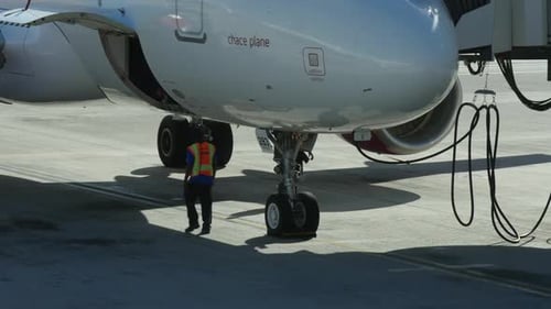 Airplane Maintenance Crew Working on Undercarriage