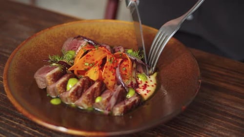 Guest or Waiter Eating Duck Meat Steak in Restaurant High Cuisine Kitchen From Famous Chef Haute