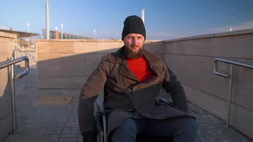 Man Smiles in Wheelchair on Ramp Outside