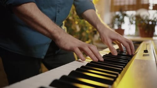 Man Plays Piano Indoors Close Up