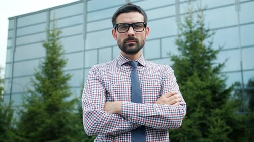 Confident Man Standing Outside Modern Office Building