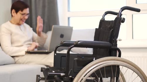 Handicapped Woman with Lapot Lay on Couch